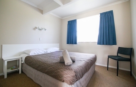 queen-size bed in 2-bedroom unit
